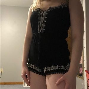 Spaghetti strap black romper with lace design